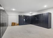 Thumbnail 91 of 127 - A room with a wall of lockers and a couple of cardboard boxes on the floor.