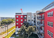 Thumbnail 3 of 140 - Aerial view of colorful apartment building with courtyard at Matador Apartments, Texas, 78745