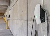 Thumbnail 95 of 127 - A white and black electric vehicle charging station with a green light on.