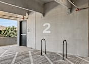 Thumbnail 96 of 127 - A concrete wall with a number 2 on it and a black door.