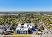 Thumbnail 91 of 140 - Aerial view of apartment building with rooftop parking at Matador Apartments, Austin, 78745