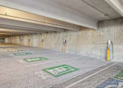 Thumbnail 98 of 127 - A parking garage with green and white parking spots.