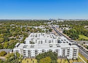 Thumbnail 95 of 140 - Aerial view of rooftop with downtown skyline at Matador Apartments, Texas, 78745