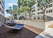 Thumbnail 107 of 127 - A modern outdoor area with hammocks and a metal fence.