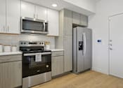 Thumbnail 54 of 116 - A modern kitchen with a stainless steel refrigerator and oven. at Park South Apartments, Texas