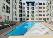 Thumbnail 118 of 127 - A swimming pool in front of apartment buildings with a "4 IN NO DIVING" sign.