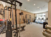 Thumbnail 14 of 46 - A gym with a variety of equipment including a treadmill, weights, and a bench press.