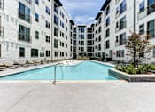 Thumbnail 2 of 46 - A swimming pool in front of a white building.