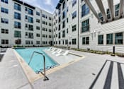 Thumbnail 3 of 46 - A swimming pool is located on the rooftop of a building.
