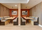 Thumbnail 9 of 46 - A modern dining room with a long table and chairs.