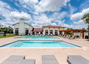 Thumbnail 25 of 59 - a swimming pool with lounge chairs and a building in the background at Avery Ranch, Texas, 78717