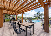 Thumbnail 28 of 59 - the reserve at bucklin hill leasing office patio with pergola and pool at Avery Ranch, Austin