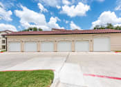 Thumbnail 44 of 59 - a building with three garages and a blue sky with white clouds at Avery Ranch, Texas, 78717