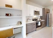 Thumbnail 13 of 21 - A modern kitchen with a white bathtub.