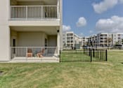 Thumbnail 51 of 103 - Ground floor covered patio with metal railing at Cantarra Apartments, Manor, TX 78653