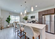 Thumbnail 83 of 103 - Open concept kitchen with island seating at Cantarra Apartments, Manor, 78653