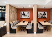 Thumbnail 34 of 46 - A modern dining room with a long table and chairs.