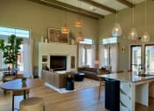 Thumbnail 49 of 52 - a living room with a fireplace and a kitchen with a table and chairs at Delco Flats, Texas