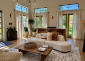 Thumbnail 46 of 52 - a living room filled with furniture and a large window at Delco Flats, Austin, 78717