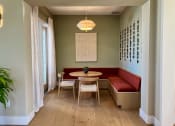 Thumbnail 43 of 52 - a small dining room with a red bench and a wooden table at Delco Flats, Texas, 78717