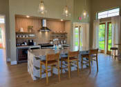 Thumbnail 42 of 52 - a kitchen with a large center island with a marble countertop at Delco Flats, Texas