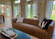 Thumbnail 41 of 52 - a living room with a brown couch and a blue coffee table at Delco Flats, Austin