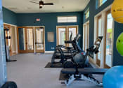 Thumbnail 38 of 52 - a gym with cardio equipment and weights at Delco Flats, Austin, Texas