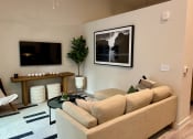 Thumbnail 8 of 44 - a living room with a couch and a television at windsor park towers