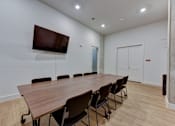Thumbnail 47 of 140 - Conference room with wall mounted tv at Matador Apartments, Austin, TX 78745