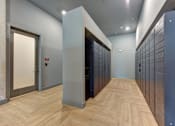Thumbnail 45 of 140 - Mail room with package lockers and herringbone flooring at Matador Apartments, Austin, 78745