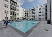 Thumbnail 53 of 140 - Courtyard pool surrounded by modern apartment buildings at Matador Apartments, Austin, TX 78745
