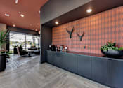 Thumbnail 36 of 140 - Modern lobby with patterned accent wall and credenza at Matador Apartments, Austin, TX