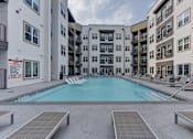 Thumbnail 58 of 140 - Courtyard pool with lounge chairs and balconies at Matador Apartments, Texas, 78745