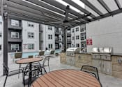 Thumbnail 62 of 140 - Outdoor grilling area with built in barbecues under pergola at Matador Apartments, Austin, Texas