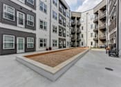 Thumbnail 69 of 140 - Outdoor courtyard with gravel bed and concrete pathways at Matador Apartments, Austin