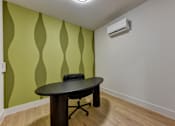 Thumbnail 50 of 140 - Small office with modern desk and accent wall at Matador Apartments, Texas