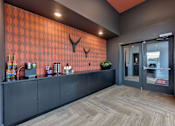 Thumbnail 37 of 140 - Coffee bar with tile accent wall and refreshments at Matador Apartments, Austin
