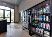 Thumbnail 39 of 140 - Lobby with beverage refrigerators and glass entrance doors at Matador Apartments, Texas, 78745