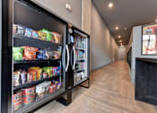 Thumbnail 40 of 140 - Hallway vending machines with snacks and beverages at Matador Apartments, Austin, TX 78745