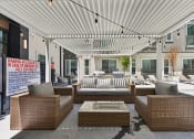 Thumbnail 31 of 44 - Seating area and grills by the pool at Bridge at Windsor Park