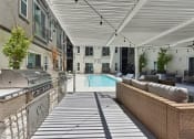 Thumbnail 30 of 44 - Poolside grills at Bridge at Windsor Park on Clayton Ln