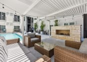 Thumbnail 26 of 44 - Luxury poolside fireplace and comfortable seating
