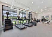 Thumbnail 20 of 44 - Bridge at Windsor Park Apartments luxury gym equipment with floor to ceiling windows