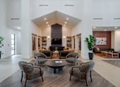 Thumbnail 3 of 55 - A modern living room with a large sofa, a coffee table, and a fireplace.