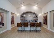 Thumbnail 5 of 55 - A modern kitchen with a bar area and chairs.