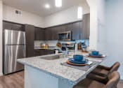 Thumbnail 3 of 65 - Granite Counters and Stainless Steel Appliances in 78754 at Bridge at Paloma