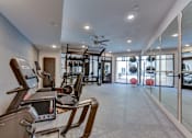Thumbnail 19 of 51 - A gym with treadmills, weights, and exercise balls.