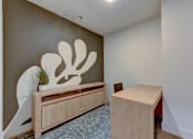 Thumbnail 29 of 51 - A room with a wooden bench and a wall art.