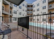 Thumbnail 37 of 51 - A black metal fence surrounds a pool area.