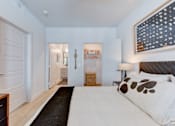 Thumbnail 40 of 51 - A bedroom with a large bed and a painting on the wall.